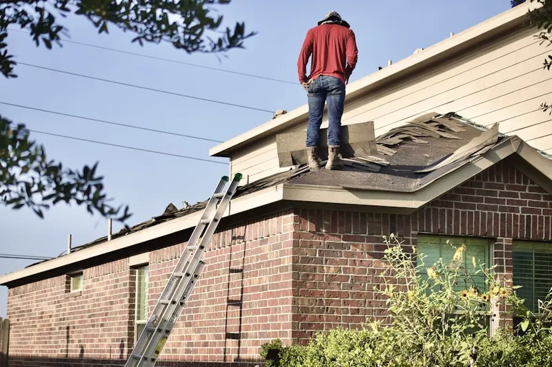 Professional roofer working on a residential roof in Westlake Place